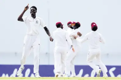  ?? PHOTO BY RICARDO MAZALAN ?? Windies bowler Alzarri Joseph (left) celebrates dismissing England’s captain, Joe Root, during day one of the second Test cricket match at the Sir Vivian Richards Stadium in North Sound, Antigua and Barbuda on Thursday, January 31, 2019.