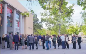  ??  ?? Some of the nearly 2,000 attendees stand in line at Popejoy Hall at UNM on Sunday for the memorial for Jennifer Riordan, who died last week in a midflight explosion.