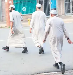  ??  ?? Ahmed Haffejee (third from right) the man who allegedly stabbed the Moulana at a mosque in Durban and is linked to the Durban bombings leaves the Verulam magistrate’s court after being granted bail - PHOTO: Jackie Clausen/Sunday Times