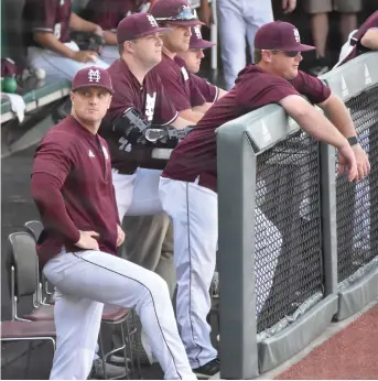  ?? (Photo by Jason Cleveland, SDN) ?? Mississipp­i State baseball coach Andy Cannizaro, left, looks up from the dugout during Friday’s first game against Alabama.