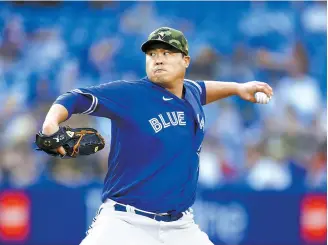  ?? AFP-Yonhap ?? Ryu Hyun-jin of the Toronto Blue Jays delivers a pitch in the third inning during an MLB game against the Cincinnati Reds at Rogers Centre in Toronto, May 20.