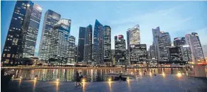  ??  ?? Singapore boasts a slick night-time skyline.