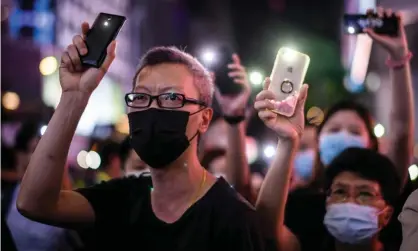  ?? Photograph: Anthony Wallace/AFP/Getty Images ?? Pro-democracy protesters in Hong Kong hold up their mobile phones. The territory faces a dramatic decline in internet freedoms.