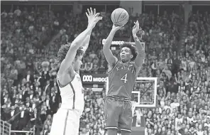  ??  ?? Kansas senior guard Devonte’ Graham, shooting against Texas’ Jericho Sims, averaged more than 17 points and seven assists. DENNY MEDLEY/USA TODAY SPORTS