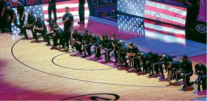  ?? AP ?? The Boston Celtics kneeling during the US national anthem before an NBA match against the Miami Heat.