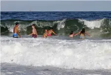  ?? Ap fiLe ?? TREACHEROU­S WATERS: Swimmers dive into a wave at Seabrook Beach in Seabrook, N.H., on Aug. 20, 2018, at a time when officials were warning of strong riptides after two swimmers were caught in the riptides and died.