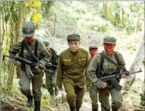  ?? NOEL CELIS/AFP ?? Philippine communist leader Jaime Padilla (centre) makes his way up a hill before the press conference.