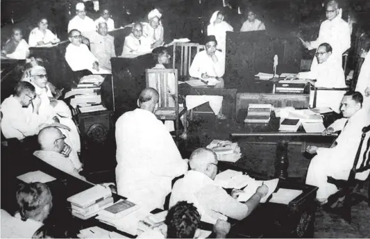  ??  ?? ARCHITECTS IN ACTION: ( Left) A Constituen­t Assembly of India meeting in 1950. B R Ambedkar can be seen seated top-right; ( below, from left) K M Munshi and B N Rau