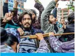  ?? — AFP ?? KATHMANDU: Police detain demonstrat­ors during a protest against India’s newly inaugurate­d link road to the Chinese border in front of the parliament yesterday.