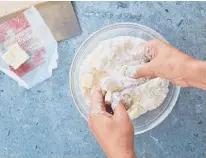  ?? ?? Cold butter is rubbed into a dry mixture by hand to help create the pie crust.