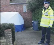  ??  ?? Below, A police guard and, right, floral tributes to Natasha and Simon at the house in Dickens Avenue, Canterbury, where they died