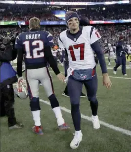  ?? CHARLES KRUPA — THE ASSOCIATED PRESS FILE ?? In this file photo, New England Patriots quarterbac­k Tom Brady (12) and Houston Texans quarterbac­k Brock Osweiler (17) pass at midfield after the Patriots won the AFC Divisional round matchup in Foxborough, Mass. The best quarterbac­ks never become free...