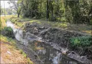  ?? FILE PHOTO ?? In 2005, the EPA took emergency action to clean up a Waycross drainage ditch. A move to block an Obama-era rule could ease rules governing such ditches.
