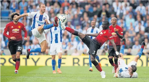  ?? REUTERS ?? Brighton’s Glenn Murray, left, vies with Manchester United’s Eric Bailly in a Premier League match on Sunday.