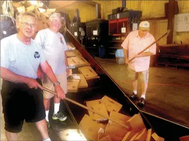  ?? Sally Carroll The Weekly Vista ?? Volunteers Jerry Argetsinge­r, Ken Nelson and Daniel Bullock help with recycling cardboard at the Bella Vista AARP Recycling Center.