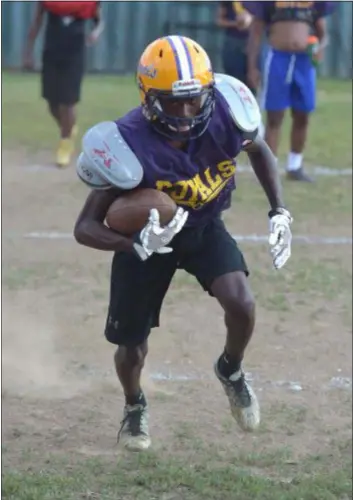  ?? PETE BANNAN — DIGITAL FIRST MEDIA ?? Upper Darby wide receiver/defensive back Shawn McCullough takes part in practice Thursday. The senior and his family lost their house to a fire last March, but the bonds of the Royals community have helped them rebuild.