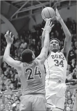  ?? Gerry Broome / AP ?? Duke’s Wendell Carter Jr. (34) shoots over Virginia Tech’s Kerry Blackshear Jr. (24) during the first half of Wednesday’s game in Durham, N.C.