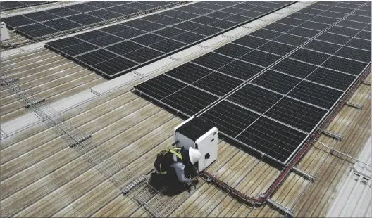  ?? AP PHOTO/MARCO UGARTE ?? A worker works among the Solar Panels installed by Pireos Power on the roof of a warehouse in the State of Mexico on on Wednesday.