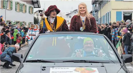  ?? FOTO: SGIER ?? Das Prinzenpaa­r der Narrenzunf­t Nibelgau, Lisa-Marie Mayer und Mike Seibold, gab sich beim Narrenspru­ng in Beuren erstmals öffentlich die Ehre. Chauffiert wurden die beiden von Helmut Koch, der bereits seit 50 Jahren den Leutkirche­r Narren angehört.