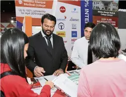  ??  ?? Manipal Internatio­nal University Business Developmen­t and Marketing assistant manager Sivabalan Krishnan (second from left) says the university offered scholarshi­ps and free foundation programmes at their booth during the fair.