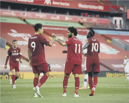  ?? PICTURE: SHAUN BOTTERILL/NMC POOL/PA WIRE ?? 0 Liverpool’s Mohamed Salah celebrates scoring his side’s second goal with Roberto Firmino.