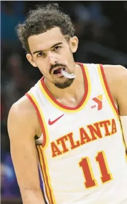  ?? AP ?? Trae Young will be out until April with torn ligaments in his hand.