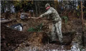  ?? Photograph: Hannibal Hanschke/EPA ?? A Ukrainian soldier digs a trench in the northern Kherson area on Sunday.