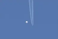  ?? (Brian Branch via AP) ?? In this photo provided by Brian Branch, a large balloon drifts above the Kingstown, N.C. area, with an airplane and its contrail seen below it.