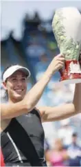  ??  ?? MASON: Garbine Muguruza, of Spain, holds the Rookwood Cup after defeating Simona Halep, of Romania, in the women’s singles final at the Western & Southern Open, Sunday, in Mason, Ohio. — AP