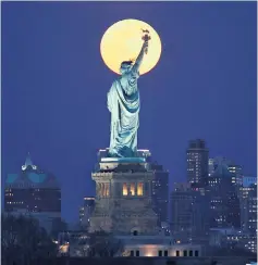  ??  ?? Shining bright: the moon over New York City in March; the Milky Way and Summer Triangle from Banff National Park, bottom