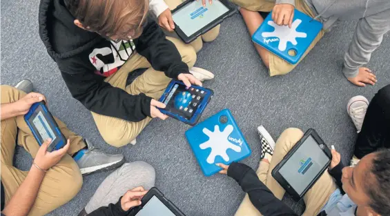  ?? FAITH NINIVAGGI PHOTOS / BOSTON HERALD ?? TAKING OWNERSHIP: Winter Hill Community School sixth graders, including Thiago and Maria, above center, and Ronnie, top, learn to code using local technology.