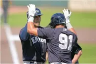  ?? (AP photo/Gerald Herbert) ?? New York Yankees Rafael Ortega is greeted at the plate Thursday by Oswald Peraza (91) after the two scored on Ortega’s two-run homer in the second inning of a MLB spring training baseball game in Bradenton, Fla.