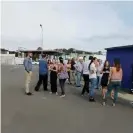  ?? Photograph: Facebook/
Jean Jacques Brunet/Reuters ?? Residents gather outside during the evacuation in Noumea.