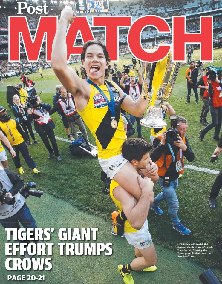  ??  ?? LIFT: Richmond’s Daniel Rioli rides on the shoulders of captain Trent Cotchin following the Tigers’ grand final win over the Adelaide Crows.