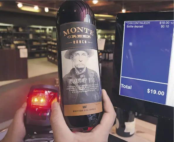  ?? ED KAISER ?? The word “DISCONTINU­ED” comes up on a checkout screen Tuesday as an employee at Jasper Wine MRKT scans a bottle of B.C. wine after Premier Rachel Notley banned imports of all B.C. wines in response to the B.C. government’s efforts to delay the Trans...