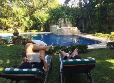  ?? Marjorie Miller / AP ?? People relax by the pool in the yard of their Airbnb rental in Cozumel, Mexico. Listings and reviews on Airbnb can tell only so much. Knowing how to read pictures can reveal more about a space.