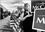  ?? LAURA SEGALL/GETTY-AFP ?? Lynn Shepherd, 51, of Chandler, Ariz., watches Thursday as the motorcade makes its way to the church in Phoenix.