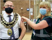  ??  ?? ●●New mayor of Stockport, councillor Adrian Nottingham, receiving the second dose of his vaccine at Heald Green Village Hall