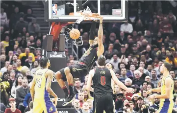  ??  ?? Cleveland Cavaliers’ LeBron James dunks in the first quarter against the Los Angeles Lakers at Quicken Loans Arena.— USA TODAY Sports photo