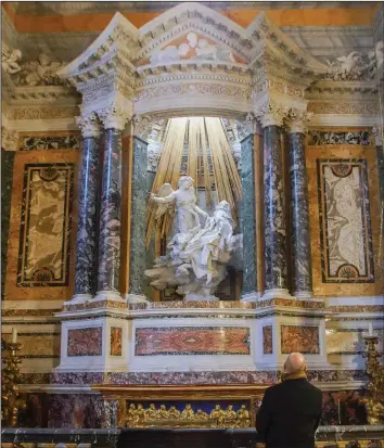  ?? (AP/Andrew Medichini) ?? Visitors take in the marble sculptural group “Ecstasy of Saint Teresa” made between 1647 and 1652, by Baroque architect and sculptor Gian Lorenzo Bernini, in the Cornaro Chapel of Rome’s Saint Mary of Victory church.