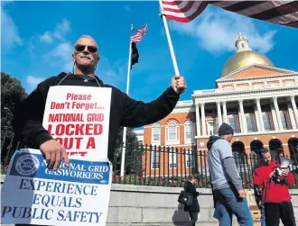  ?? ANGELA ROWLINGS / BOSTON HERALD ?? PRESSURIZE­D SITUATION: Locked-out National Grid fitter Mac McGowan, a Marine veteran who has been with the company for 12 years, rallies in front of the State House with fellow locked-out workers yesterday.