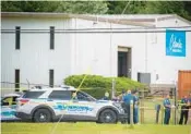  ?? BILL
GREEN/AP ?? Law enforcemen­t officials stand near the scene of a shooting at Columbia Machine, Inc., in Smithsburg, Md., Thursday.
