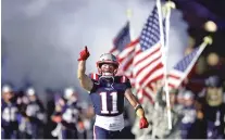  ?? CHARLES KRUPA/ASSOCIATED PRESS ?? New England Patriots wide receiver Julian Edelman charges onto the field in front of American flags before Thursday’s game against the Indianapol­is Colts, in Foxborough, Mass.