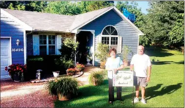  ?? Courtesy photo ?? This month’s Beaver Shores POA Yard of the Month recipients are John and Oneeta Keller at 16496 Rainbow Drive in Rogers. The backyard is like a park that is full of plants and flowers. They have been residents since 1993 in Beaver Shores. Bradford Yard...
