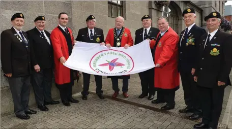 ??  ?? Cllr Frank Godfrey Mayor , Cllr Kevin Callan and Cllr Paul Bell with members of the retired forces at the raising of the Fuschia Flag at the Louth County Council Offices Fair Street Drogheda