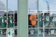  ?? SARAH KLOEPPING/USA TODAY NETWORK-WISCONSIN ?? Football jerseys are seen through the windows of the Packers Pro Shop. The store will be the first to offer Green Bay Packers NFC champions gear if the Packers defeat the Tampa Bay Buccaneers on Sunday.