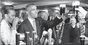  ?? IRISH GOVERNMENT/GETTY 2011 ?? President Barack Obama and first lady Michelle Obama enjoy a Guinness in Moneygall, Ireland.