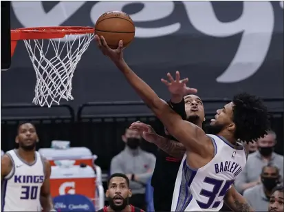  ?? PHOTOS BY RICH PEDRONCELL­I — THE ASSOCIATED PRESS ?? Sacramento Kings forward Marvin Bagley III, right, goes to the basket against Chicago Bulls forward Daniel Gafford during the first quarter in Sacramento on Wednesday.
