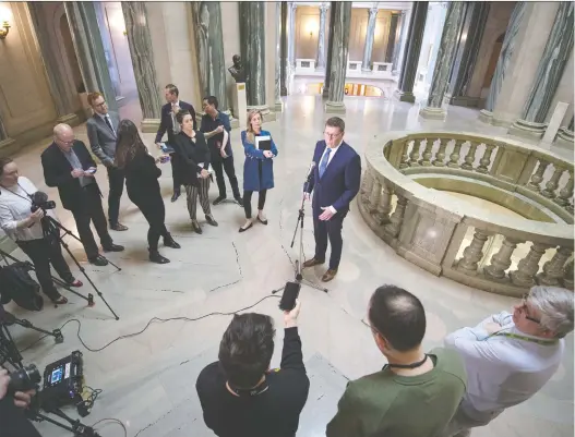  ?? BRANDON HARDER ?? Members of the media keep a safe distance as part of social distancing protocols as Premier Scott Moe speaks at the Saskatchew­an Legislativ­e Building.