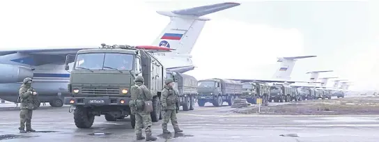  ?? REUTERS ?? Russian troops and military vehicles at Almaty airport, as part of a peacekeepi­ng mission of the Collective Security Treaty Organisati­on, in Almaty, Kazakhstan on Sunday.